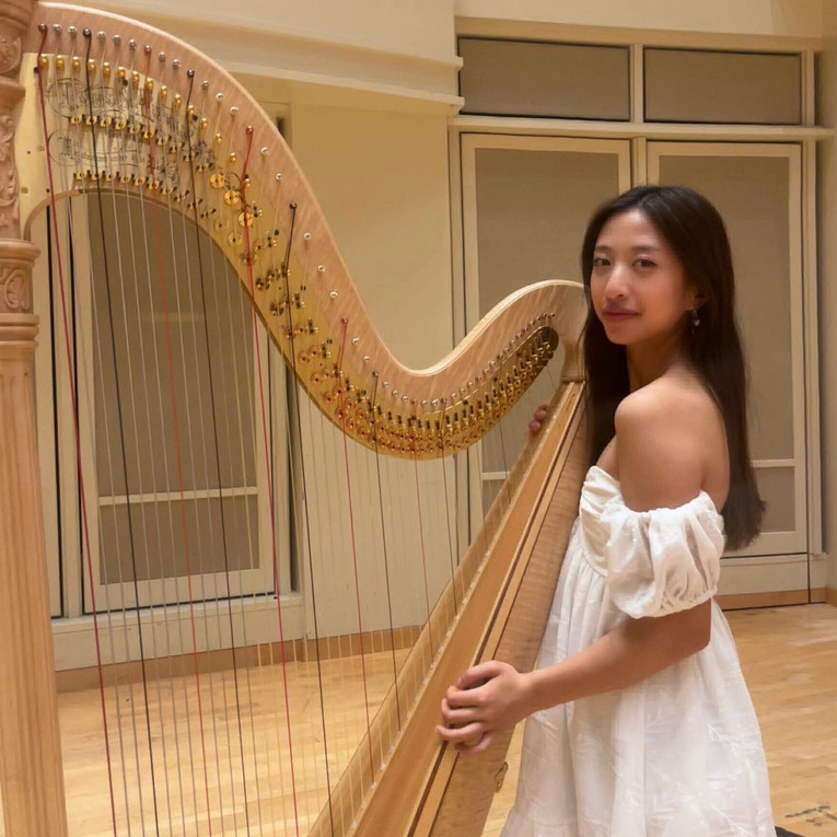 woman posing with a harp